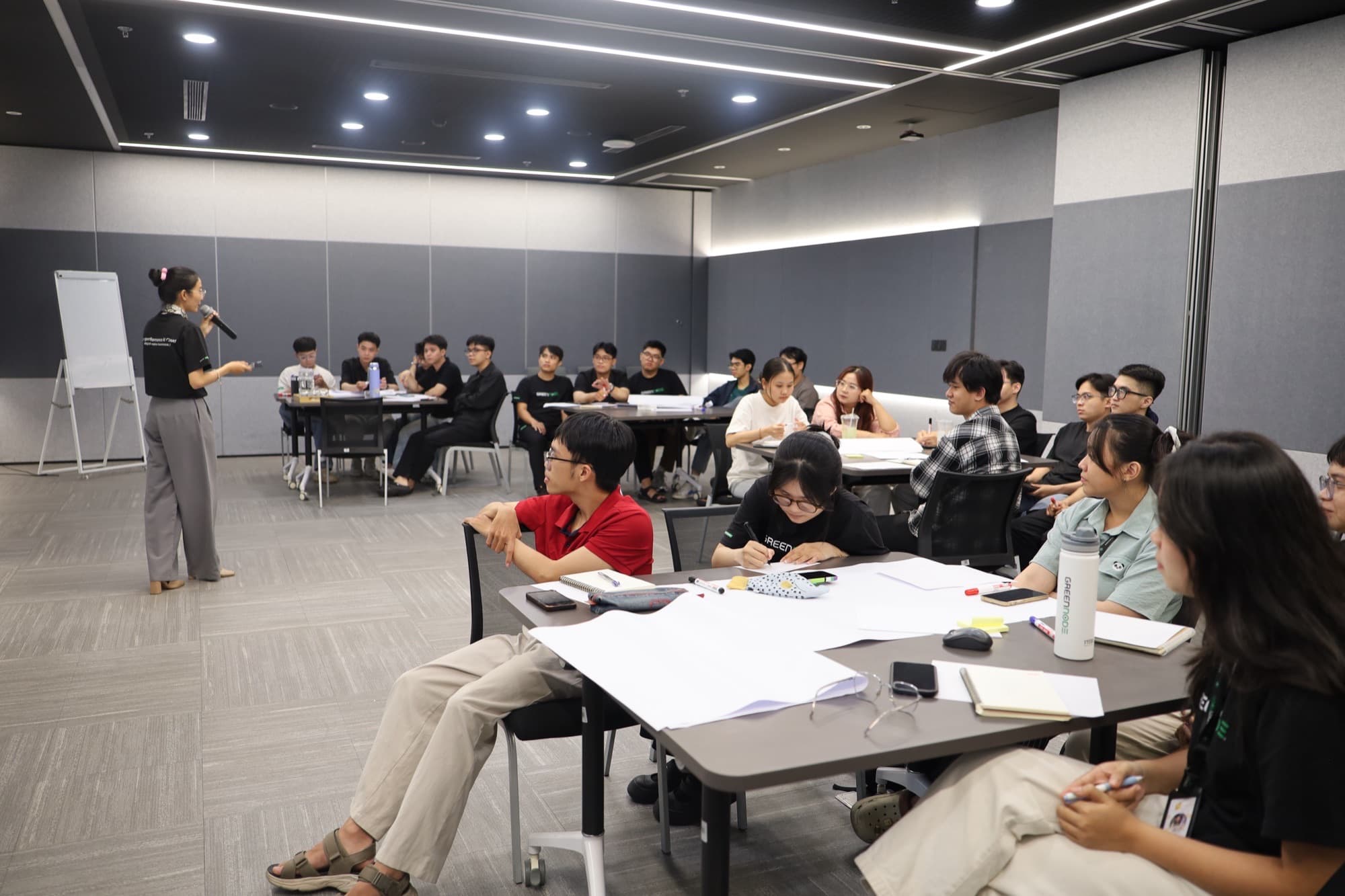 Hana đứng lớp buổi Requirement Clarification cho intern GreenNode, các bạn làm bài tập trên giấy A3